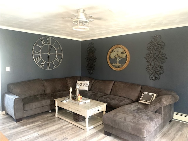 living room with hardwood / wood-style flooring, ceiling fan, and baseboard heating