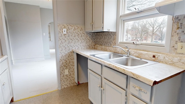 kitchen featuring tasteful backsplash and sink