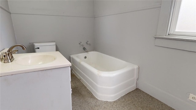 bathroom with vanity, toilet, and a bath