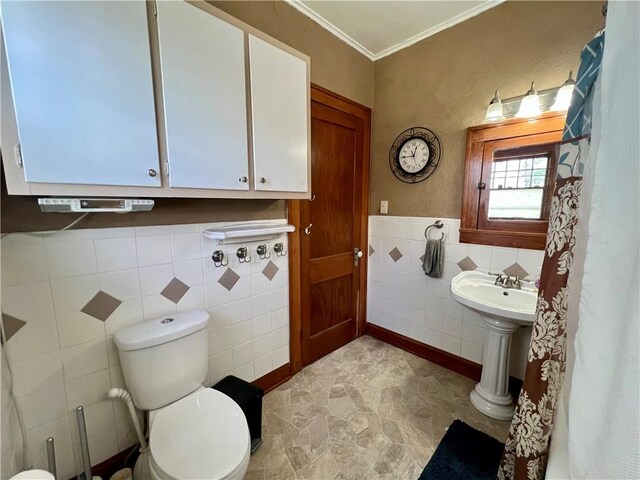 402 Gray St, Sidell, IL 61876 - bathroom featuring crown molding, tile walls, toilet, a wainscoted wall, and a sink