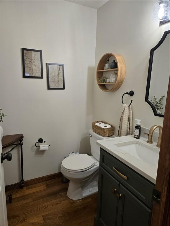 1008 Schroll Dr, Forsyth, IL 62535 - half bath featuring wood finished floors and vanity