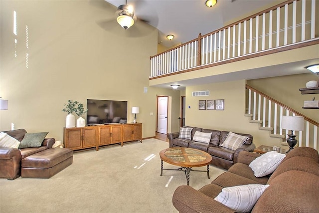 1008 Schroll Dr, Forsyth, IL 62535 - living area featuring a towering ceiling, light carpet, ceiling fan, and stairway
