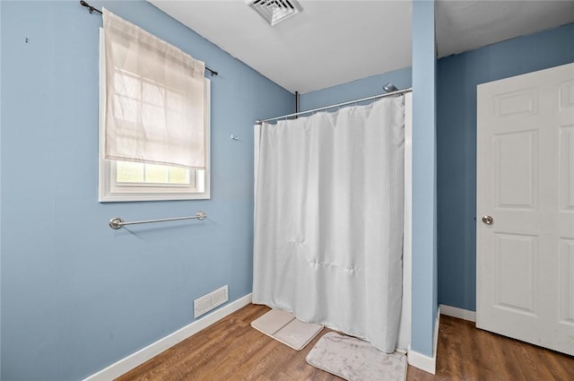 22417 N 1320th St, Marshall, IL 62441 - full bathroom featuring wood finished floors, baseboards, and a shower with shower curtain