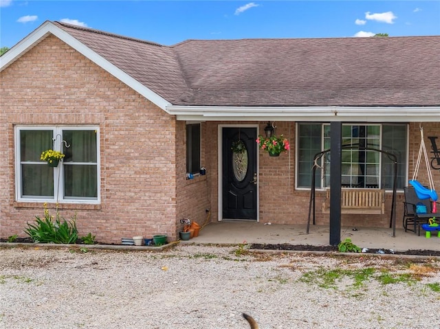22417 N 1320th St, Marshall, IL 62441 - doorway to property featuring brick siding and a shingled roof