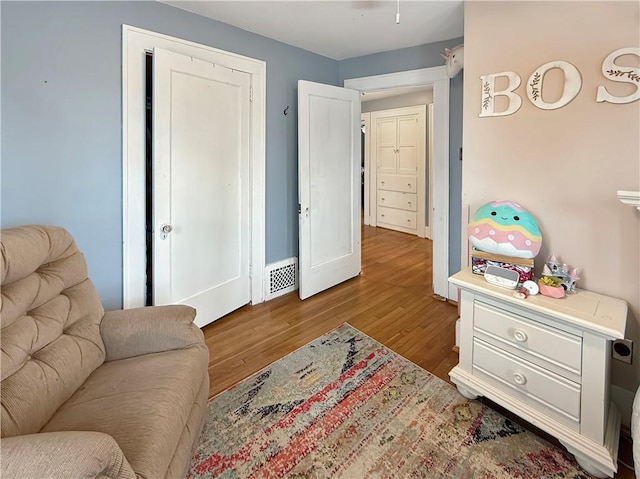 sitting room featuring wood finished floors and visible vents