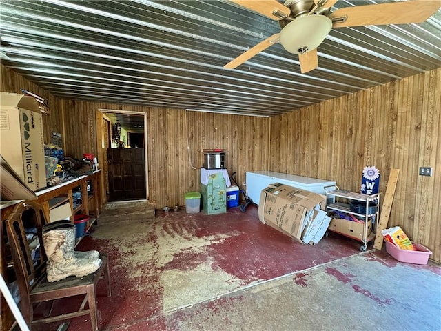 bedroom featuring unfinished concrete floors and wooden walls