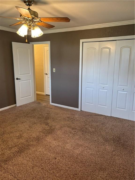 905 W Evergreen Ave, Effingham, IL 62401 - unfurnished bedroom with carpet flooring, a closet, crown molding, and ceiling fan