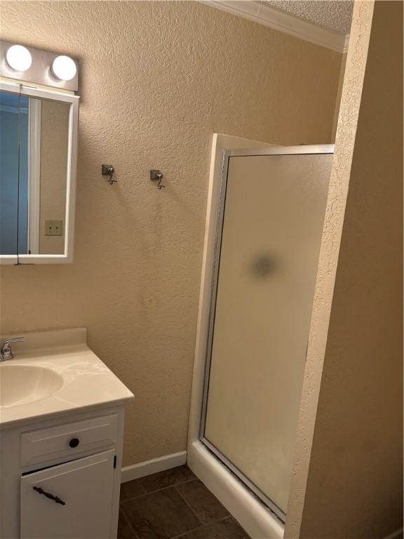 905 W Evergreen Ave, Effingham, IL 62401 - full bath featuring vanity, a stall shower, and tile patterned flooring