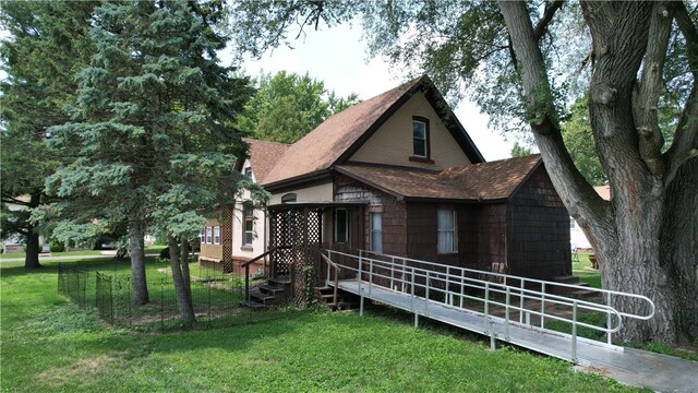 rear view of house featuring a lawn