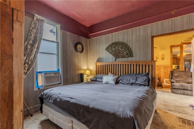 bedroom with carpet flooring, cooling unit, and wooden walls