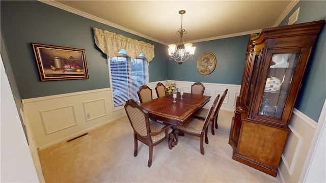 carpeted dining area with a notable chandelier and crown molding