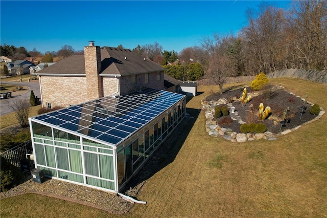 exterior space with a lawn and solar panels