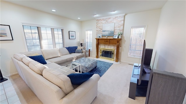 carpeted living room featuring a healthy amount of sunlight and a fireplace