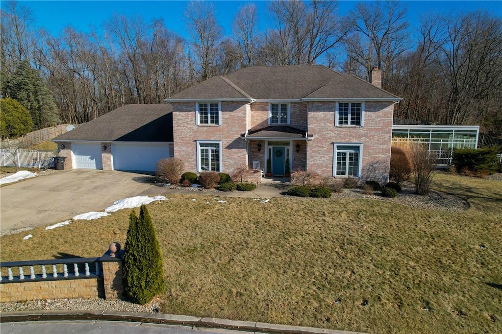 view of front of home with a garage and a front lawn