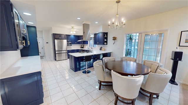 dining space with sink, light tile patterned floors, and a notable chandelier