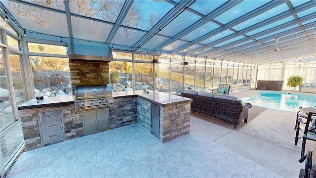 view of patio / terrace featuring an outdoor kitchen, a grill, and exterior bar