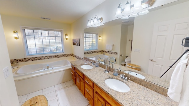 bathroom with tile patterned flooring, vanity, a bath, and toilet