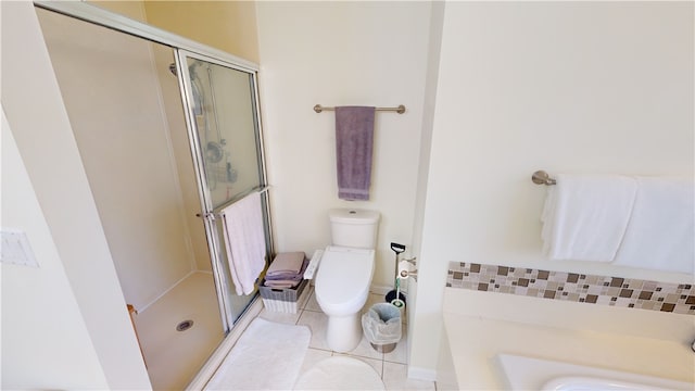 bathroom with tile patterned flooring, a shower with shower door, and toilet