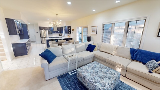 living room with light tile patterned flooring and an inviting chandelier