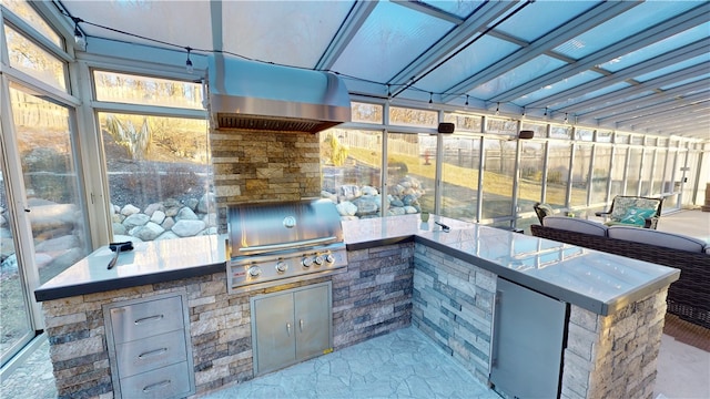 view of patio / terrace with an outdoor kitchen and a grill