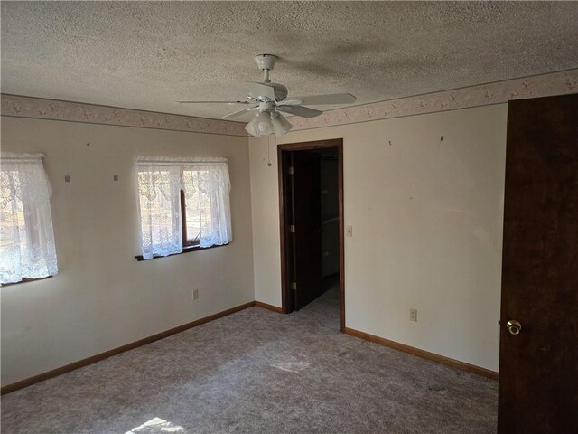 20746 E 400 N, Charleston, IL 61920 - unfurnished bedroom featuring carpet, a textured ceiling, baseboards, and a ceiling fan