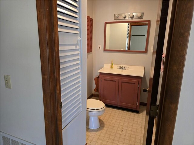 20746 E 400 N, Charleston, IL 61920 - half bathroom featuring toilet, vanity, and tile patterned floors