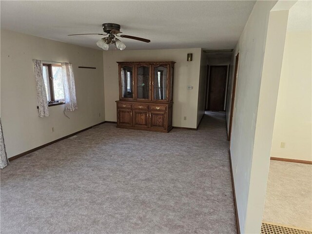 20746 E 400 N, Charleston, IL 61920 - empty room featuring light colored carpet, a ceiling fan, and baseboards