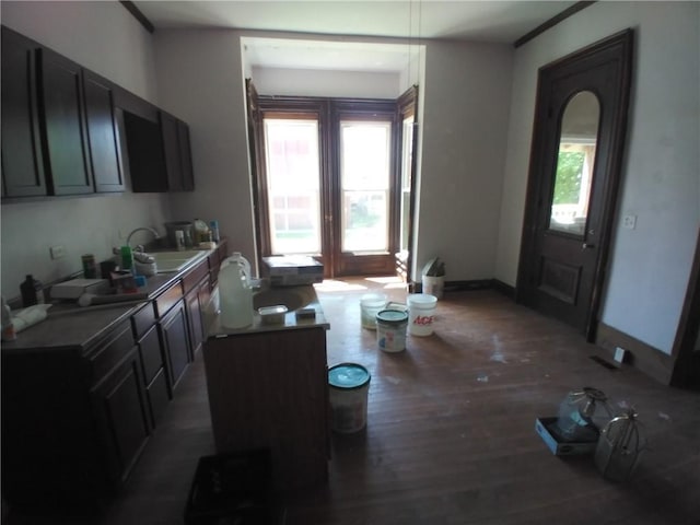 172 Broadway St, Shelbyville, IL 62565 - kitchen with a sink, dark cabinetry, baseboards, and wood finished floors