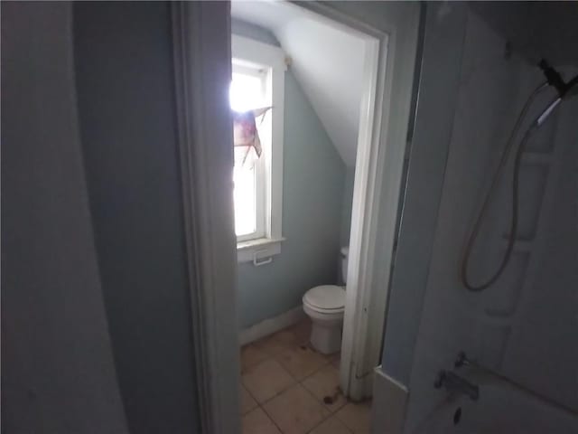 172 Broadway St, Shelbyville, IL 62565 - bathroom featuring toilet, shower / bathing tub combination, tile patterned flooring, and lofted ceiling