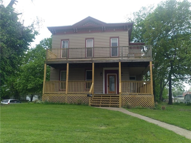 172 Broadway St, Shelbyville, IL 62565 - view of front facade with covered porch, a balcony, and a front yard