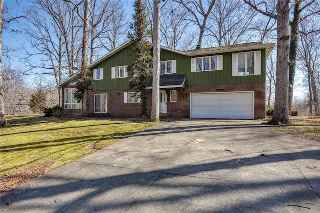 view of front of property with a garage, a front yard, brick siding, and driveway