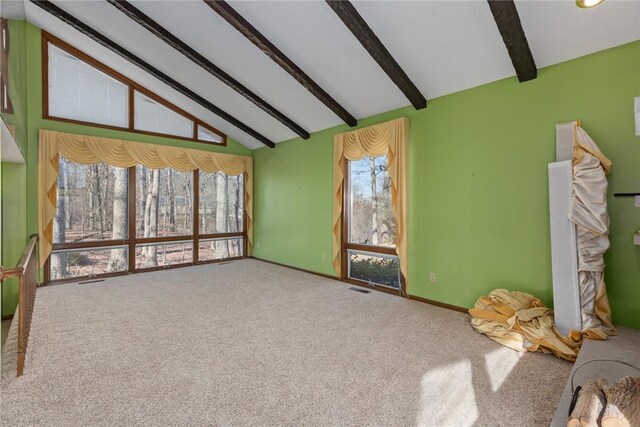 interior space featuring visible vents, baseboards, beamed ceiling, carpet flooring, and high vaulted ceiling