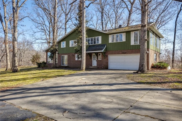 view of front of property featuring brick siding, a front lawn, concrete driveway, and a garage