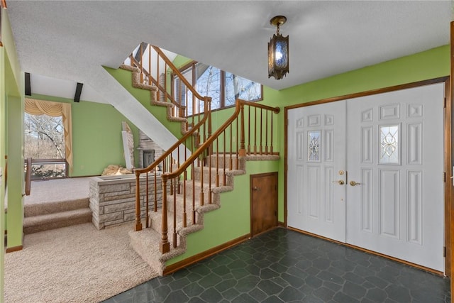 entrance foyer with stairway and baseboards