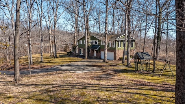 exterior space featuring brick siding, an attached garage, and driveway