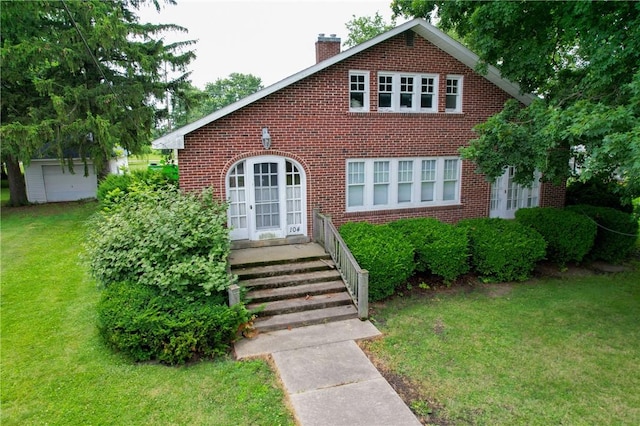 104 E N St, Ridgefarm, IL 61870 - view of front of property featuring brick siding, a chimney, and a front yard