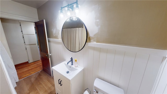 104 E N St, Ridgefarm, IL 61870 - full bathroom with wood finished floors, vanity, and wainscoting