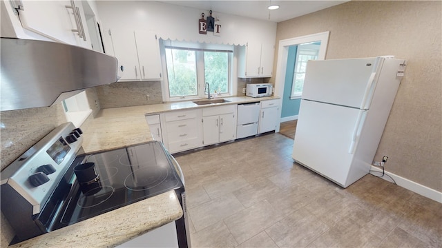 104 E N St, Ridgefarm, IL 61870 - kitchen with white appliances, backsplash, white cabinets, recessed lighting, and light stone counters
