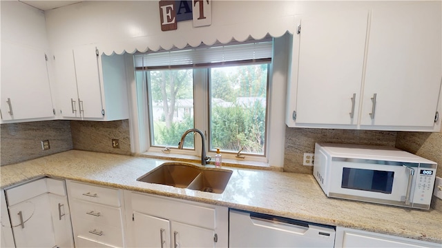 104 E N St, Ridgefarm, IL 61870 - kitchen featuring dishwasher, white microwave, decorative backsplash, and white cabinetry