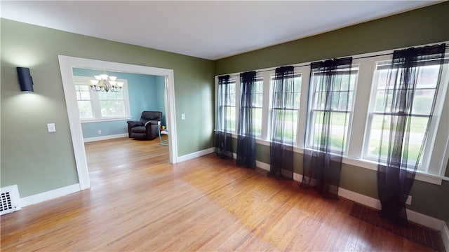 104 E N St, Ridgefarm, IL 61870 - empty room featuring a chandelier and light wood-type flooring