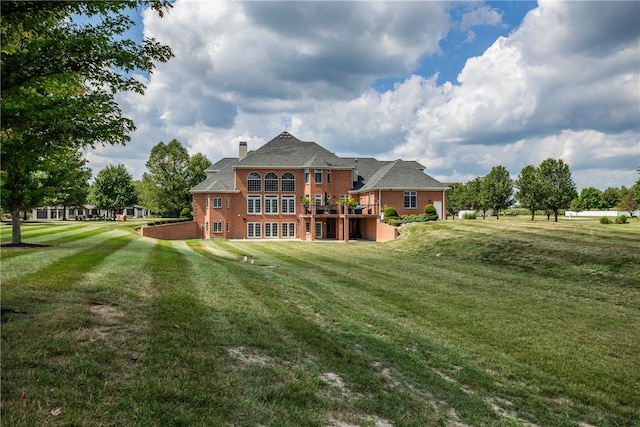 rear view of property with a lawn