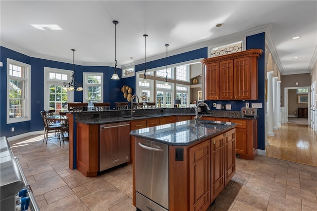 kitchen featuring kitchen peninsula, pendant lighting, stainless steel dishwasher, and plenty of natural light