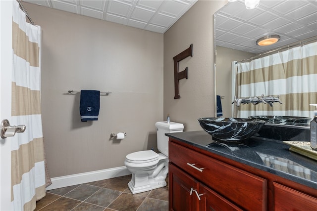 bathroom featuring tile patterned flooring, vanity, and toilet