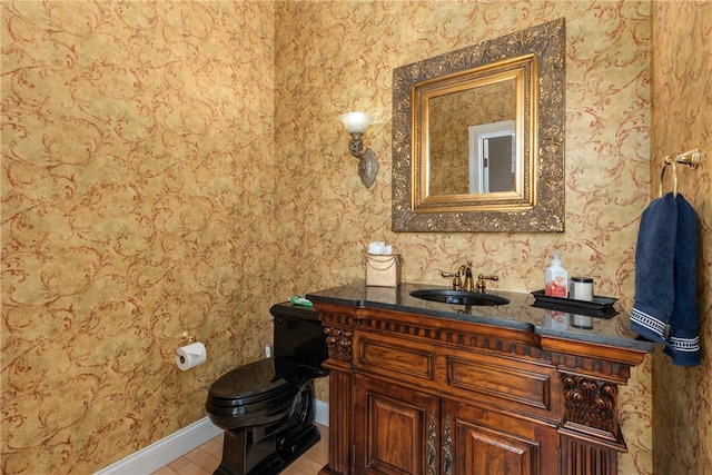 bathroom with tile patterned flooring, vanity, and toilet