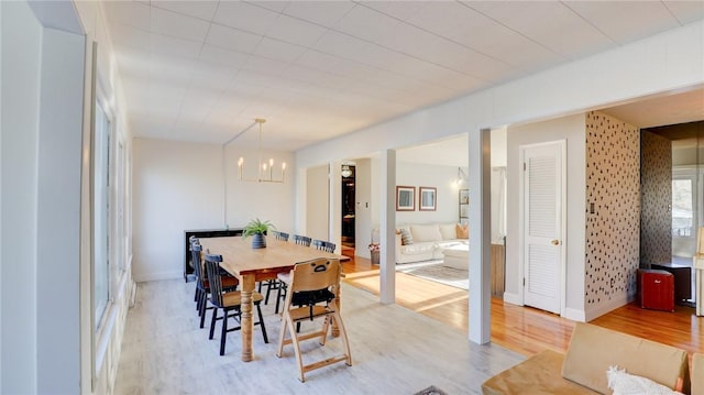 dining area with a chandelier and light hardwood / wood-style floors