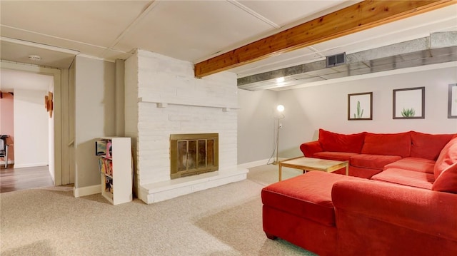 carpeted living room featuring a fireplace and beam ceiling