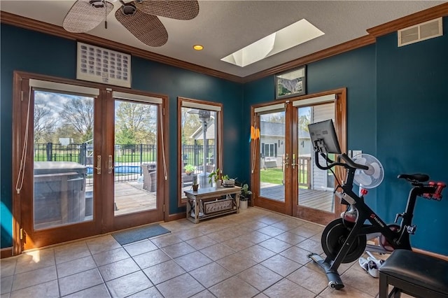 workout area with ornamental molding, french doors, and visible vents