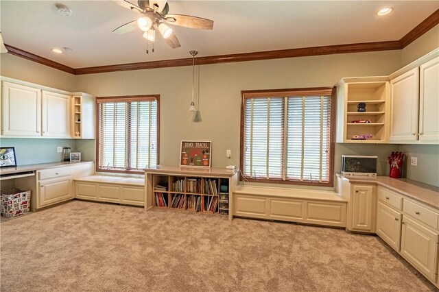 kitchen featuring built in desk, crown molding, open shelves, and light colored carpet