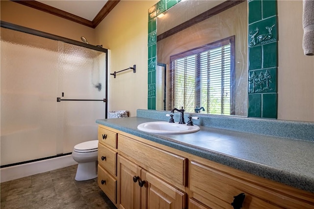 bathroom with a shower stall, toilet, vanity, and ornamental molding
