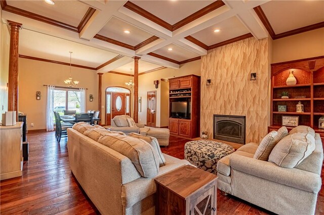 living room featuring dark wood finished floors, coffered ceiling, beamed ceiling, ornate columns, and crown molding